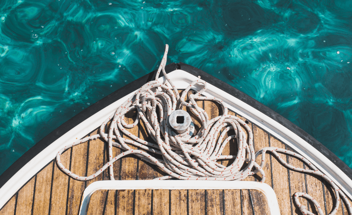 Bow of boat with rope spread across deck